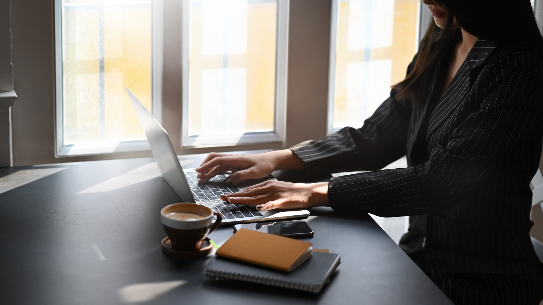 Executive Woman Typing on a Laptop